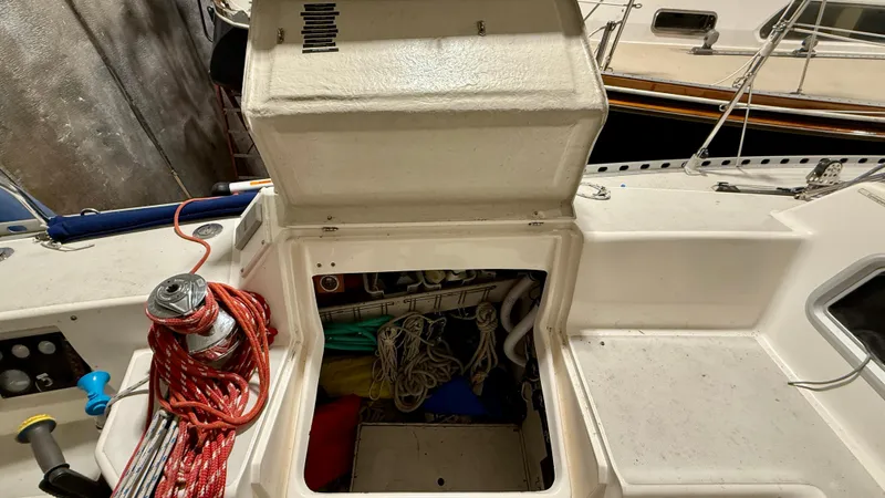 Slide: The Image of 1989 J Boats J/40 sailboat cockpit storage with ropes and equipment. - 14