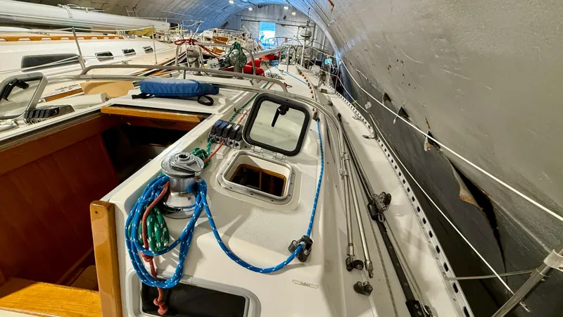 Slide: The Image of 1989 J Boats J/40 sailboat deck with rigging and equipment in storage. - 15