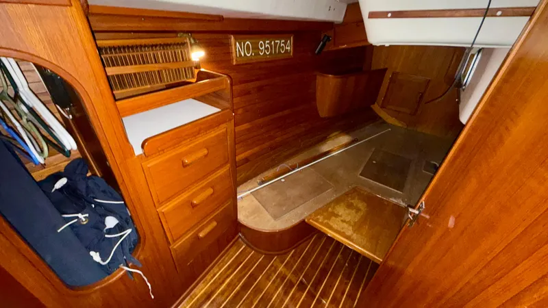 Slide: The Image of 1989 J Boats J/40 interior cabin with wooden finish and storage compartments. - 20