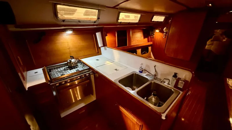 Slide: The Image of Interior of 1989 J Boats J/40 yacht kitchen with stove and dual sinks. - 21