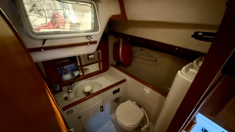 Slide: The Image of 1989 J Boats J/40 yacht bathroom with sink, toilet, and window. - 22