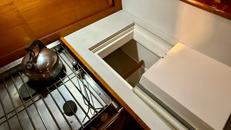 Slide: The Image of 1989 J Boats J/40 yacht galley with stove and storage compartment. - 26