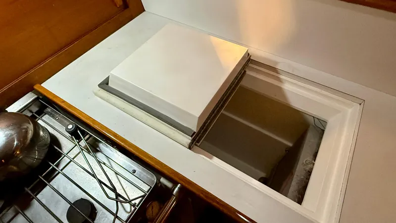 Slide: The Image of Interior view of a 1989 J Boats J/40 sailboat galley with open storage compartment. - 27