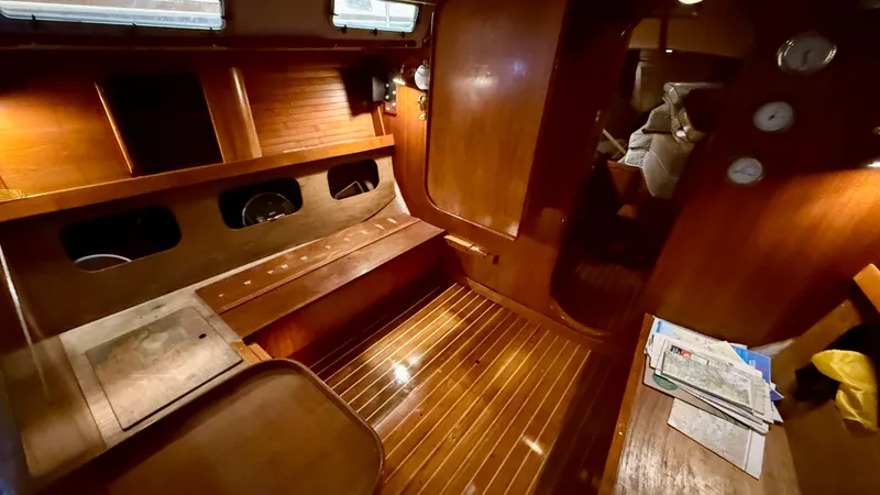 Slide: The Image of Interior of 1989 J Boats J/40 sailboat with polished wood finish and cozy seating area. - 28