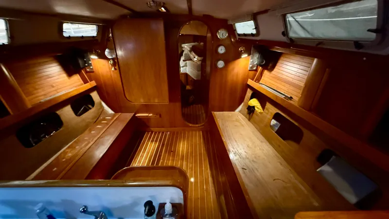 Slide: The Image of 1989 J Boats J/40 interior with wooden finish and cozy seating area. - 31
