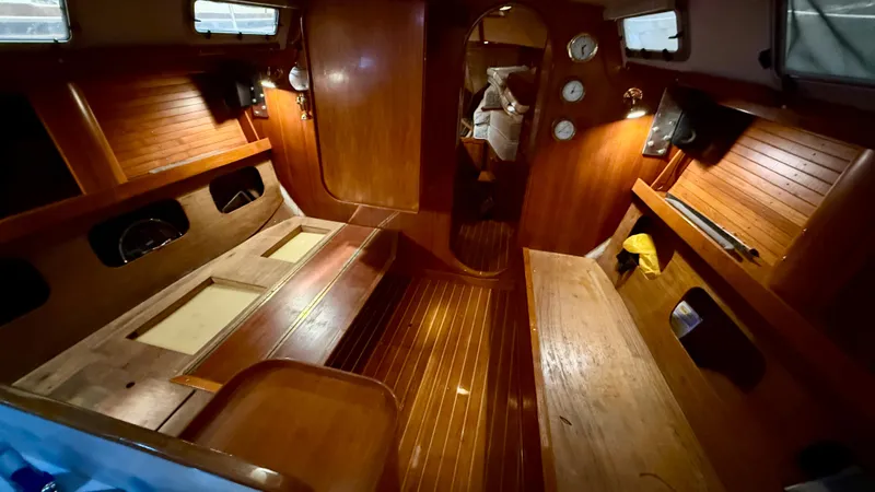Slide: The Image of 1989 J Boats J/40 interior with polished wood finish and cozy seating area. - 32