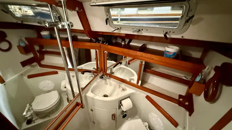 Slide: The Image of 1989 J Boats J/40 yacht bathroom with wooden accents and nautical decor. - 34