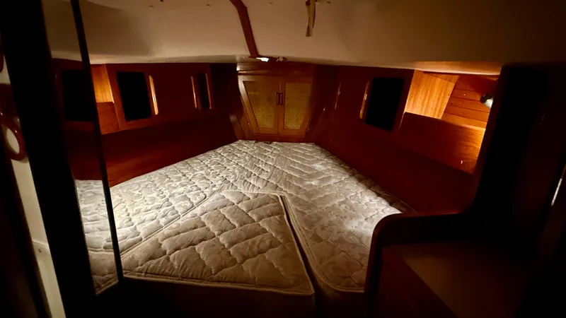 Slide: The Image of 1989 J Boats J/40 interior cabin with wooden finish and mattress. - 35