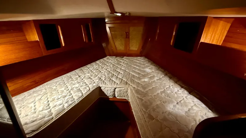 Slide: The Image of Interior cabin of 1989 J Boats J/40 with wooden finish and cozy bedding. - 36