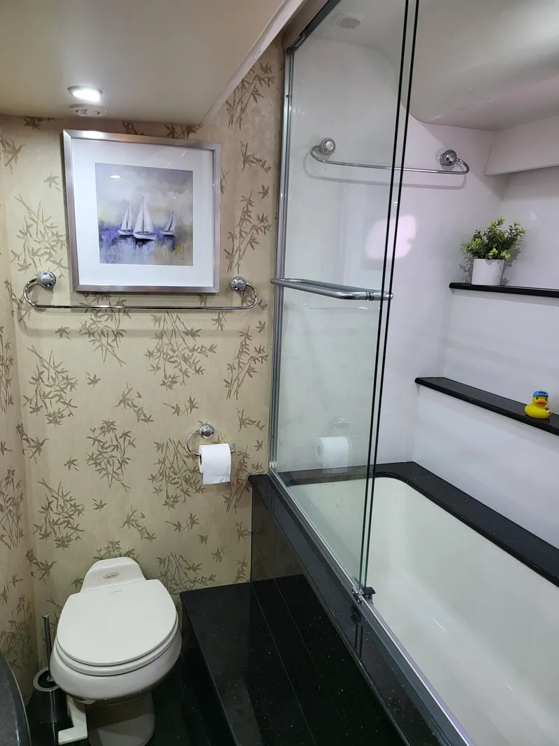 Slide: The Image of Luxurious 2004 Marquis 59 yacht bathroom with elegant decor and modern amenities. - 46