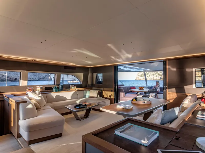 Slide: The Image of Luxurious interior of 2025 Lagoon SIXTY 7 yacht with spacious seating and ocean view. - 12