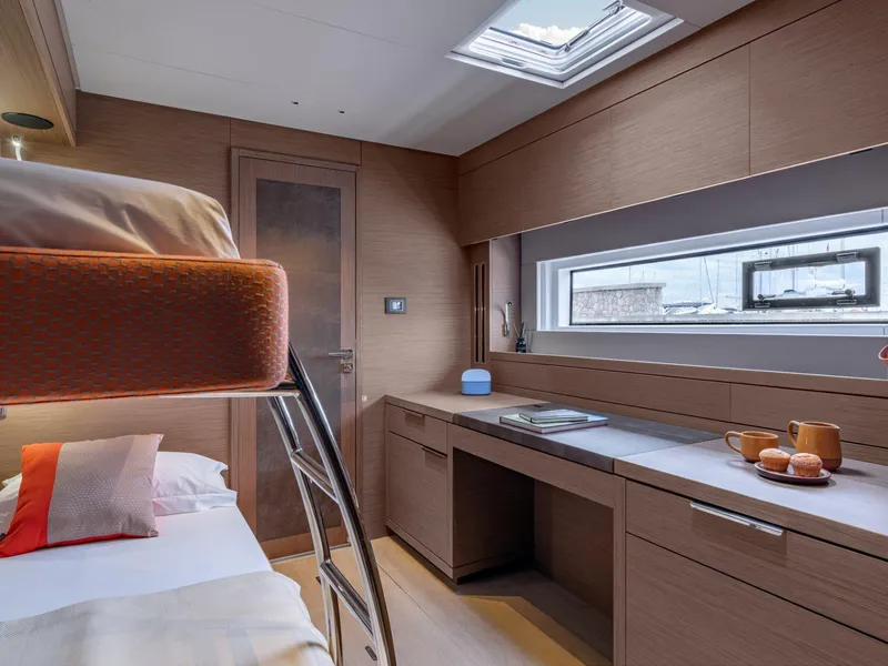 Slide: The Image of Luxurious interior of 2025 Lagoon SIXTY 7 yacht with modern bunk beds and sleek design. - 18
