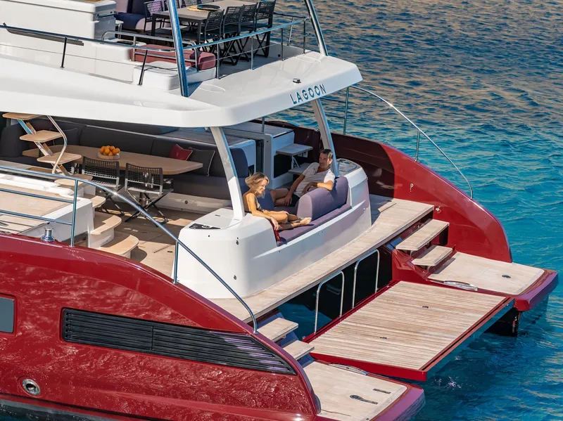 Slide: The Image of Luxury Lagoon SIXTY 7 yacht, 2025 model, with spacious deck and elegant design on clear blue water. - 5