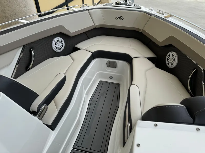 Slide: The Image of 2022 Monterey 278 Super Sport boat interior with cushioned seating and sleek design. - 11