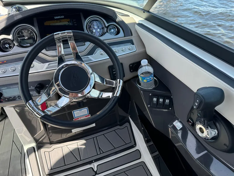 Slide: The Image of 2022 Monterey 278 Super Sport boat dashboard with steering wheel and controls. - 18