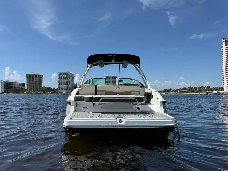 Slide: The Image of 2022 Monterey 278 Super Sport boat on water with city skyline background. - 2