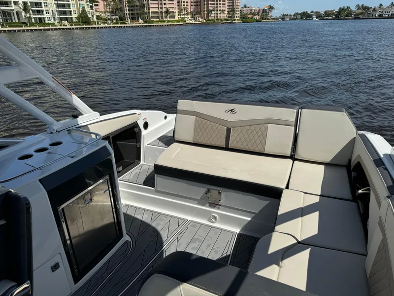 Slide: The Image of 2022 Monterey 278 Super Sport boat interior with luxurious seating by the water. - 31