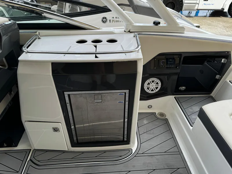 Slide: The Image of 2022 Monterey 278 Super Sport boat interior with mini fridge and sleek design. - 32