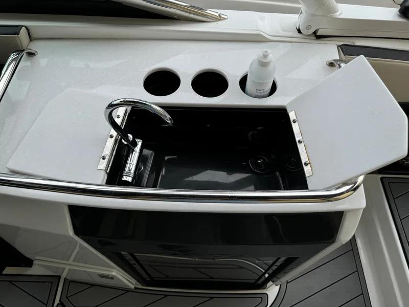 Slide: The Image of 2022 Monterey 278 Super Sport boat sink with faucet and cup holders. - 33