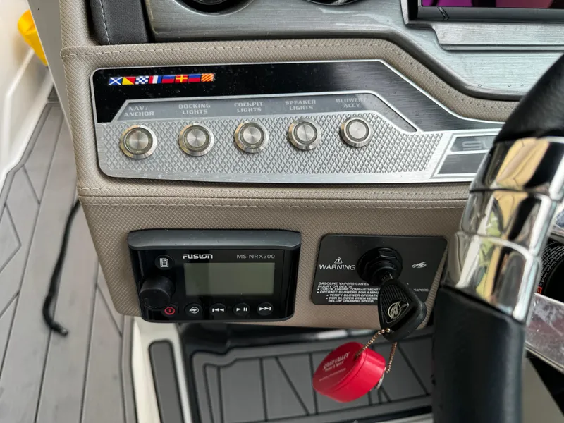 Slide: The Image of Control panel of 2022 Monterey 278 Super Sport boat with various switches and a Fusion stereo. - 42