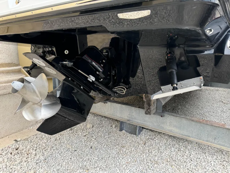 Slide: The Image of 2022 Monterey 278 Super Sport boat propeller and stern drive on gravel surface. - 47