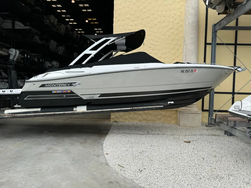 Slide: The Image of 2022 Monterey 278 Super Sport boat in storage, side view, sleek design. - 6