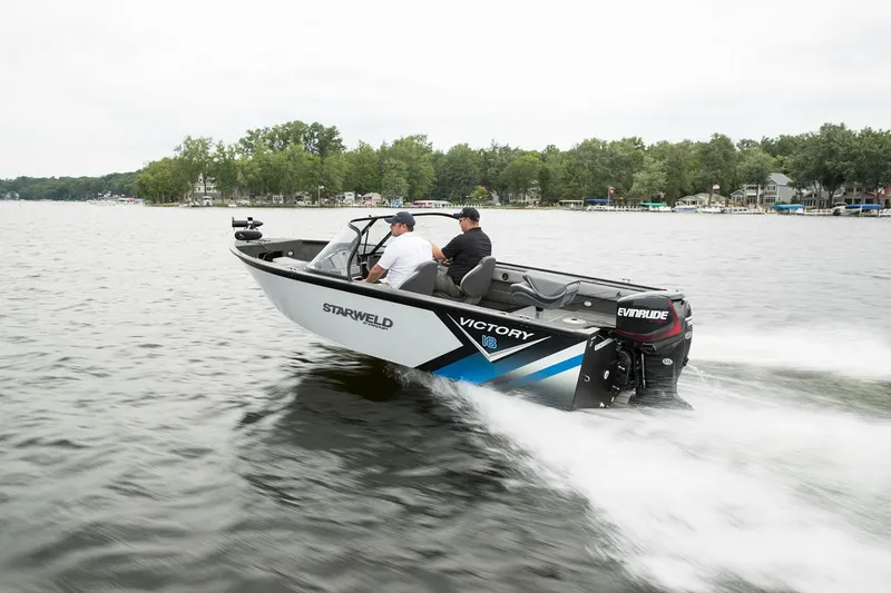 Slide: The Image of 2024 Starweld Victory 18 DC boat cruising on a lake with two passengers. - 12