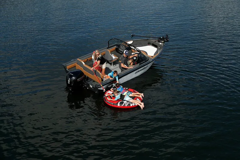 Slide: The Image of 2024 Starweld Victory 18 DC boat with family tubing on a lake. - 4