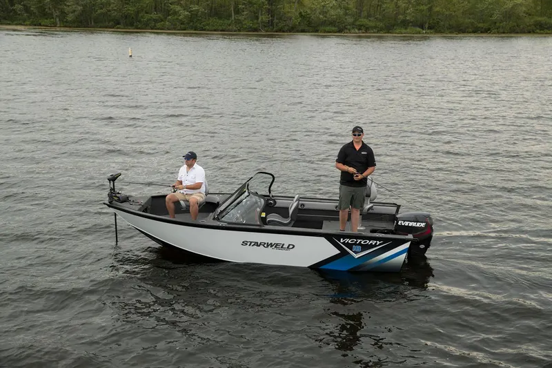 Slide: The Image of 2024 Starweld Victory 18 DC boat with two people fishing on a lake. - 6