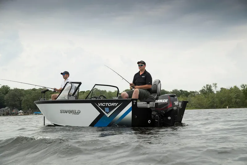 Slide: The Image of Two people fishing on a 2024 Starweld Victory 18 DC boat in a lake. - 7
