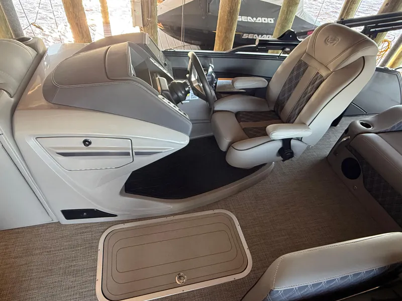 Slide: The Image of 2022 Barletta Lusso 23U boat interior with luxurious seating and modern dashboard. - 15
