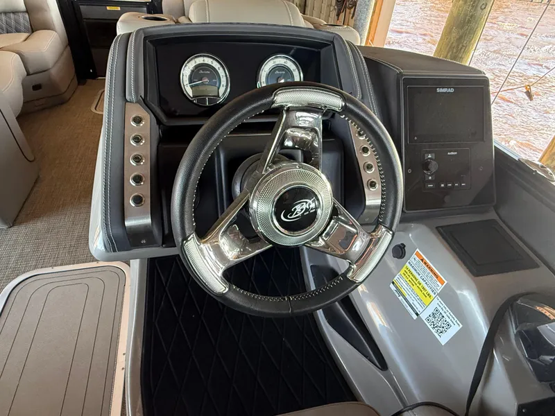 Slide: The Image of 2022 Barletta Lusso 23U boat dashboard with steering wheel and control panel. - 17