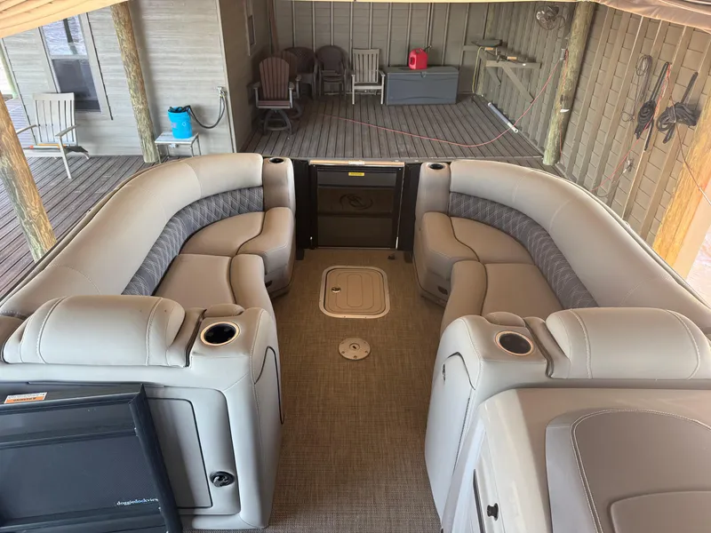 Slide: The Image of 2022 Barletta Lusso 23U pontoon boat interior with plush seating and cup holders. - 28