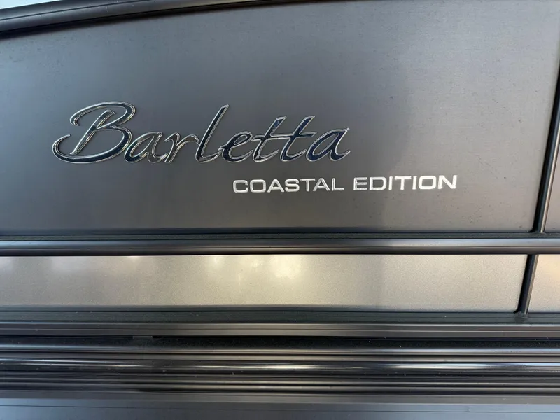 Slide: The Image of 2022 Barletta Lusso 23U Coastal Edition logo on sleek metallic surface. - 31