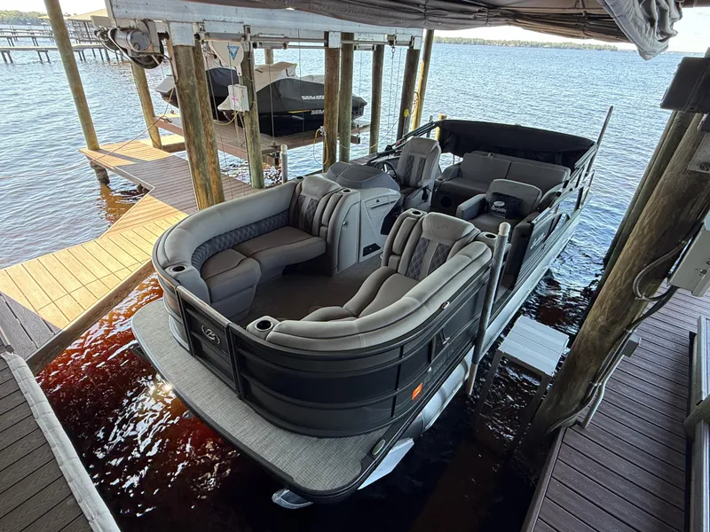 Slide: The Image of 2022 Barletta Lusso 23U pontoon boat docked, featuring luxurious seating and sleek design. - 8