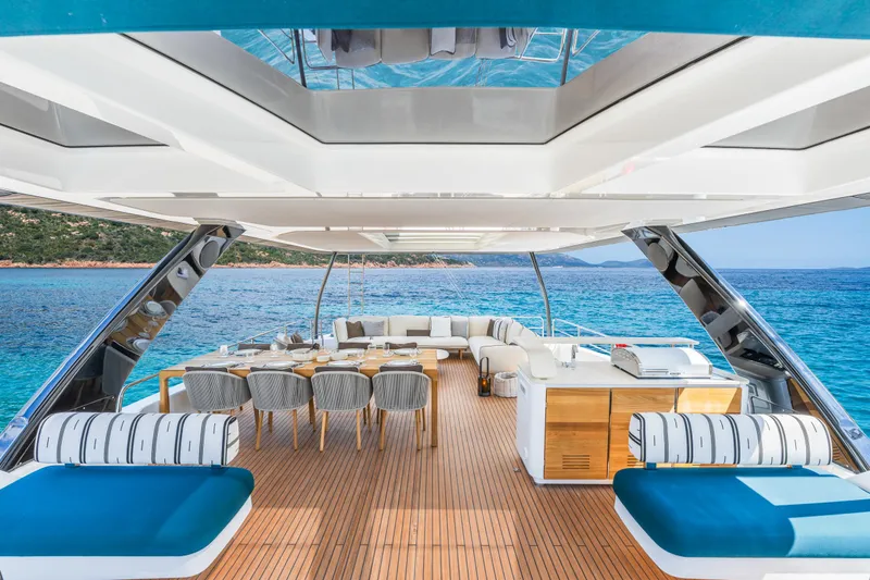 Slide: The Image of Luxurious Lagoon Eighty 2 yacht deck with stylish seating, overlooking serene blue waters and lush island. - 15