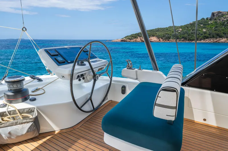 Slide: The Image of People relaxing on Lagoon Eighty 2 yacht, 2026, with one diving into the sea. - 17
