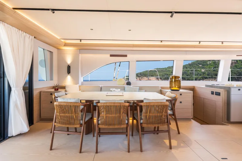 Slide: The Image of Luxurious Lagoon Eighty 2 yacht interior with elegant seating, dining area, and ocean view, 2025 model. - 20