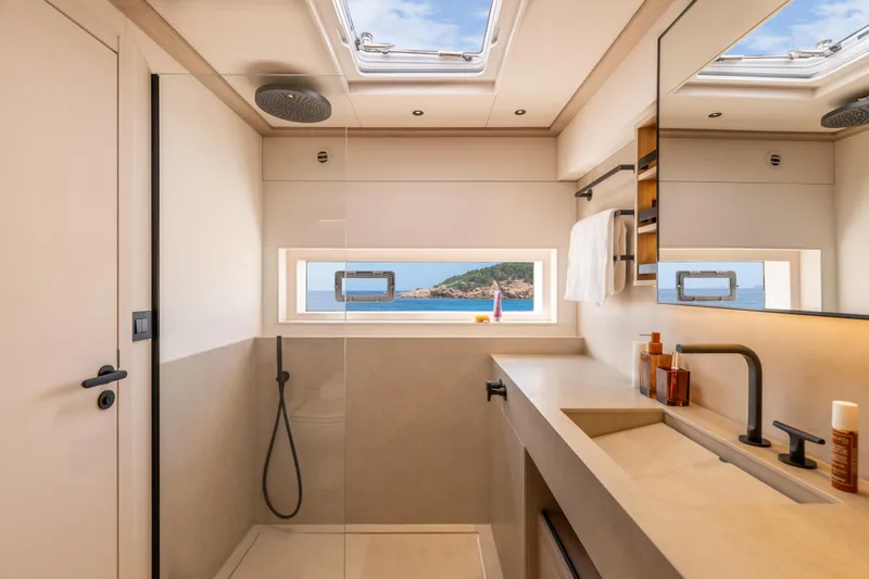 Slide: The Image of Luxurious walk-in closet on Lagoon Eighty 2 yacht, featuring wooden shelves and modern lighting, 2025 model. - 29