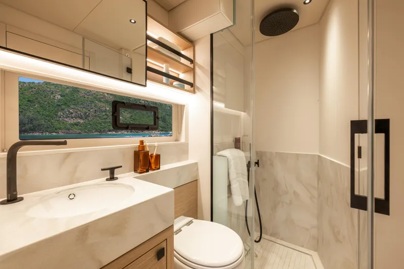 Slide: The Image of Luxurious interior of 2025 Lagoon Eighty 2 yacht cabin with modern design and natural lighting. - 36