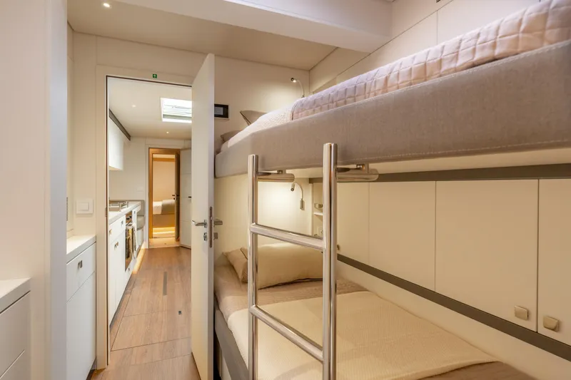 Slide: The Image of Luxurious bedroom interior of 2025 Lagoon Eighty 2 yacht with modern design and ambient lighting. - 38