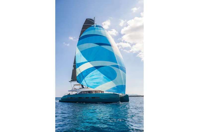 Slide: The Image of Sailing yacht Lagoon Eighty 2, 2026 model, with vibrant blue sail on open sea. - 5