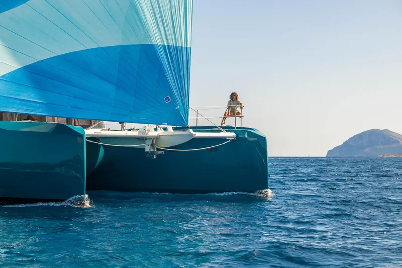 Slide: The Image of 2026 Lagoon Eighty 2 catamaran sailing with blue sail on open sea. - 6