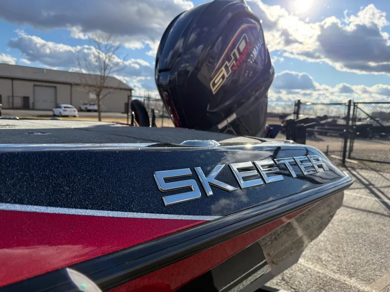 Slide: The Image of 2025 Skeeter ZXR20 boat with powerful engine, parked outdoors under a sunny sky. - 10