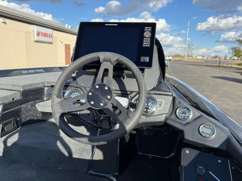 Slide: The Image of 2025 Skeeter ZXR20 boat dashboard with steering wheel and electronic display. - 12