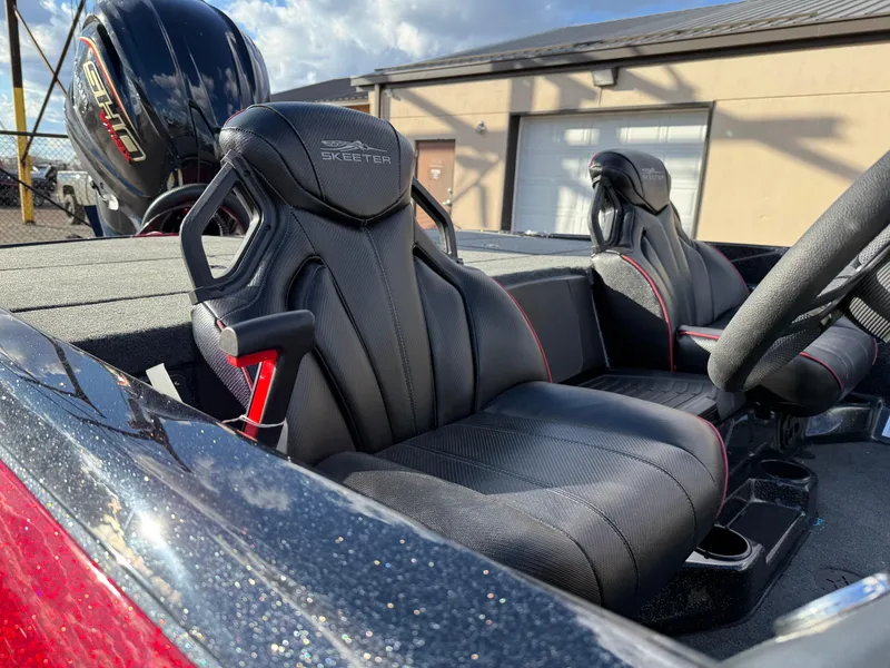 Slide: The Image of 2025 Skeeter ZXR20 boat interior with black leather seats and modern design. - 13