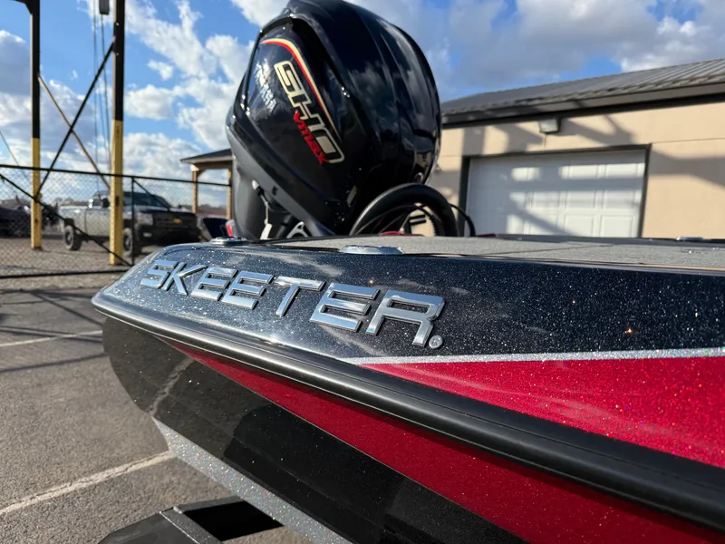 Slide: The Image of 2025 Skeeter ZXR20 boat with Yamaha engine, parked outdoors under a blue sky. - 15