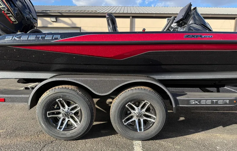 Slide: The Image of 2025 Skeeter ZXR20 boat on trailer, featuring sleek red and black design. - 16