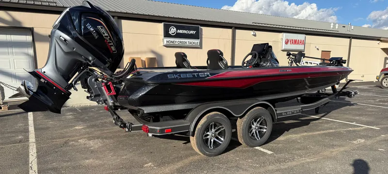 Slide: The Image of 2025 Skeeter ZXR20 boat with powerful outboard motor in dealership parking lot. - 5