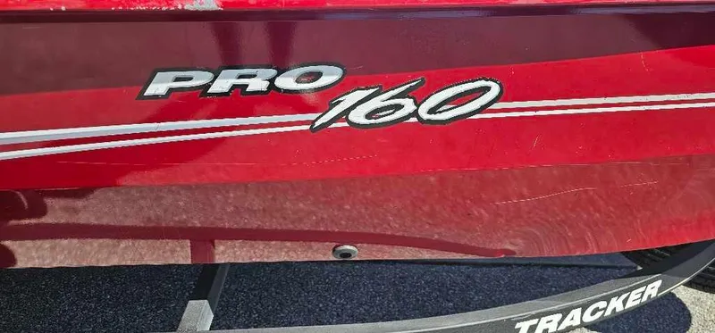 Slide: The Image of 2019 Tracker Pro 160 boat, red exterior with model branding. - 2
